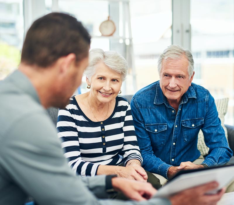 senior couple talking to lawyer