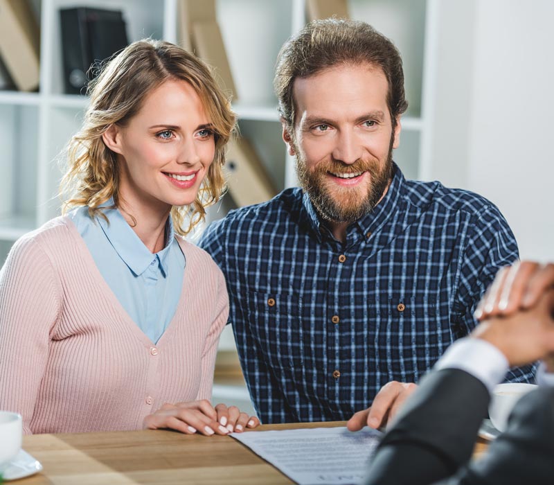 middle aged couple talking to lawyer